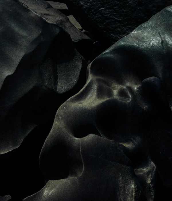 Abstract geometric shapes balancing on a dark surface